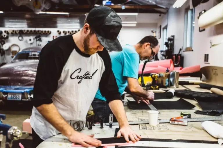 Father-son team at Northwest Crafted Interiors working on a Porsche 911 interior restoration in Everett